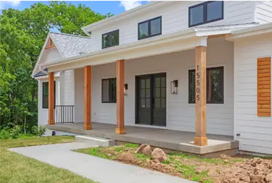 Modern house with porch and greenery