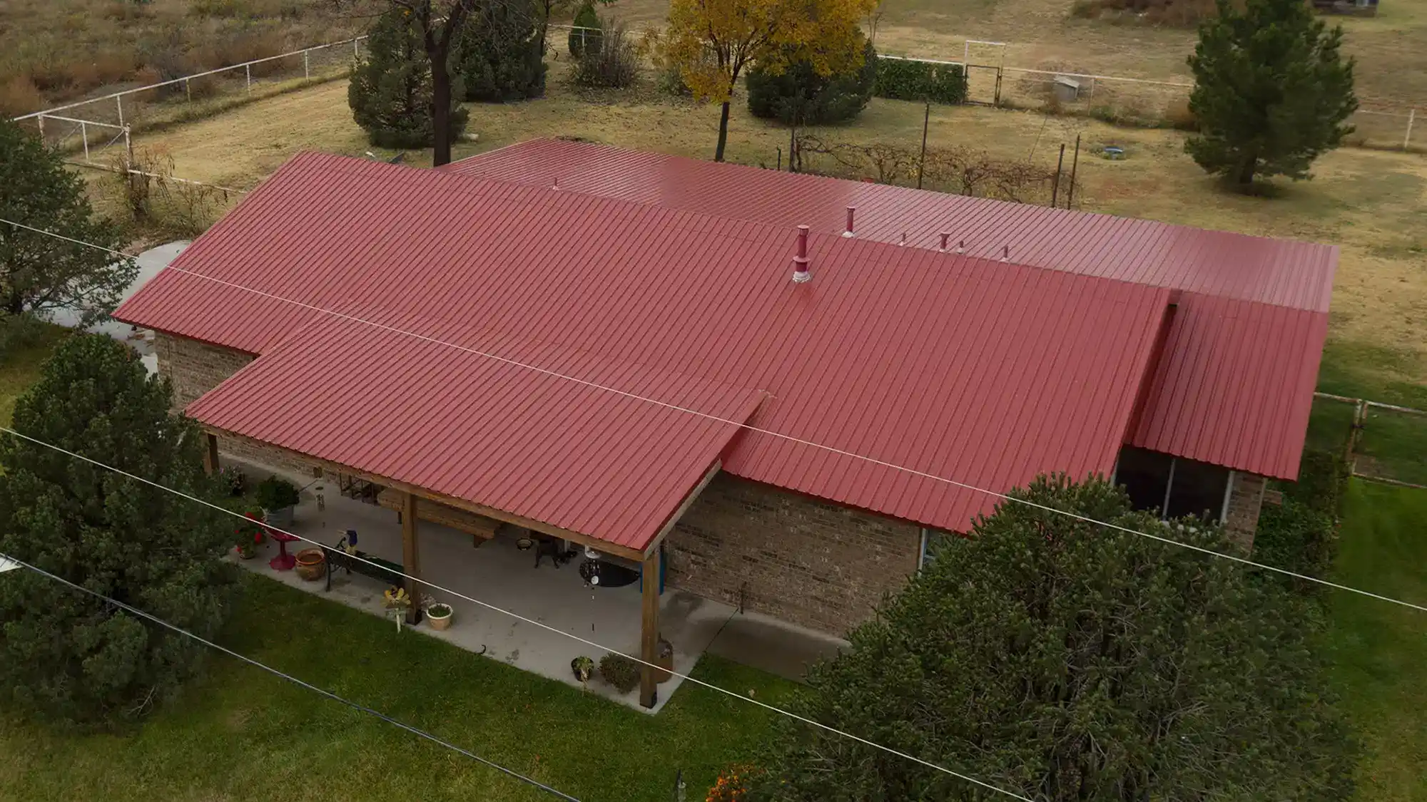 Red Metal Roof With Overhang In A Park Area