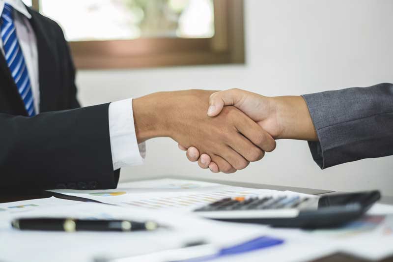 Home owner and financing consultant shaking hands